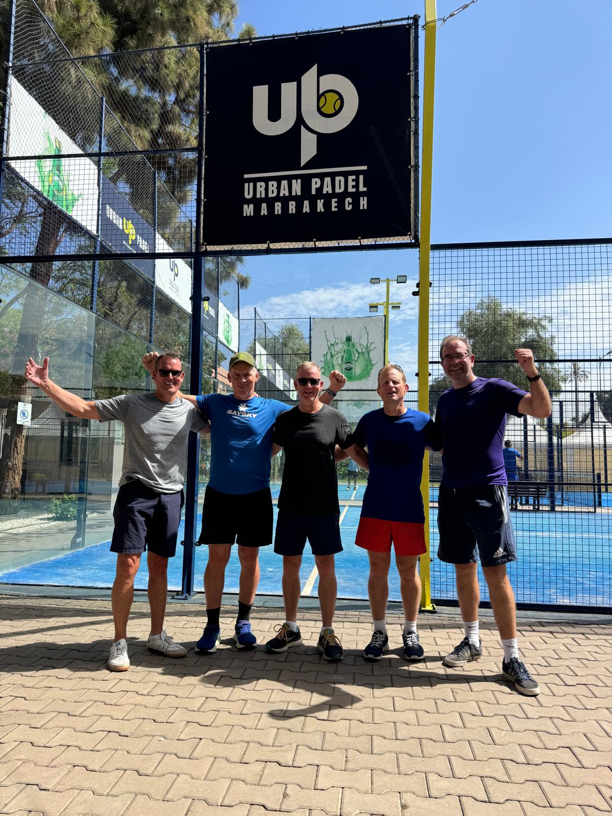 The padel group posing on court