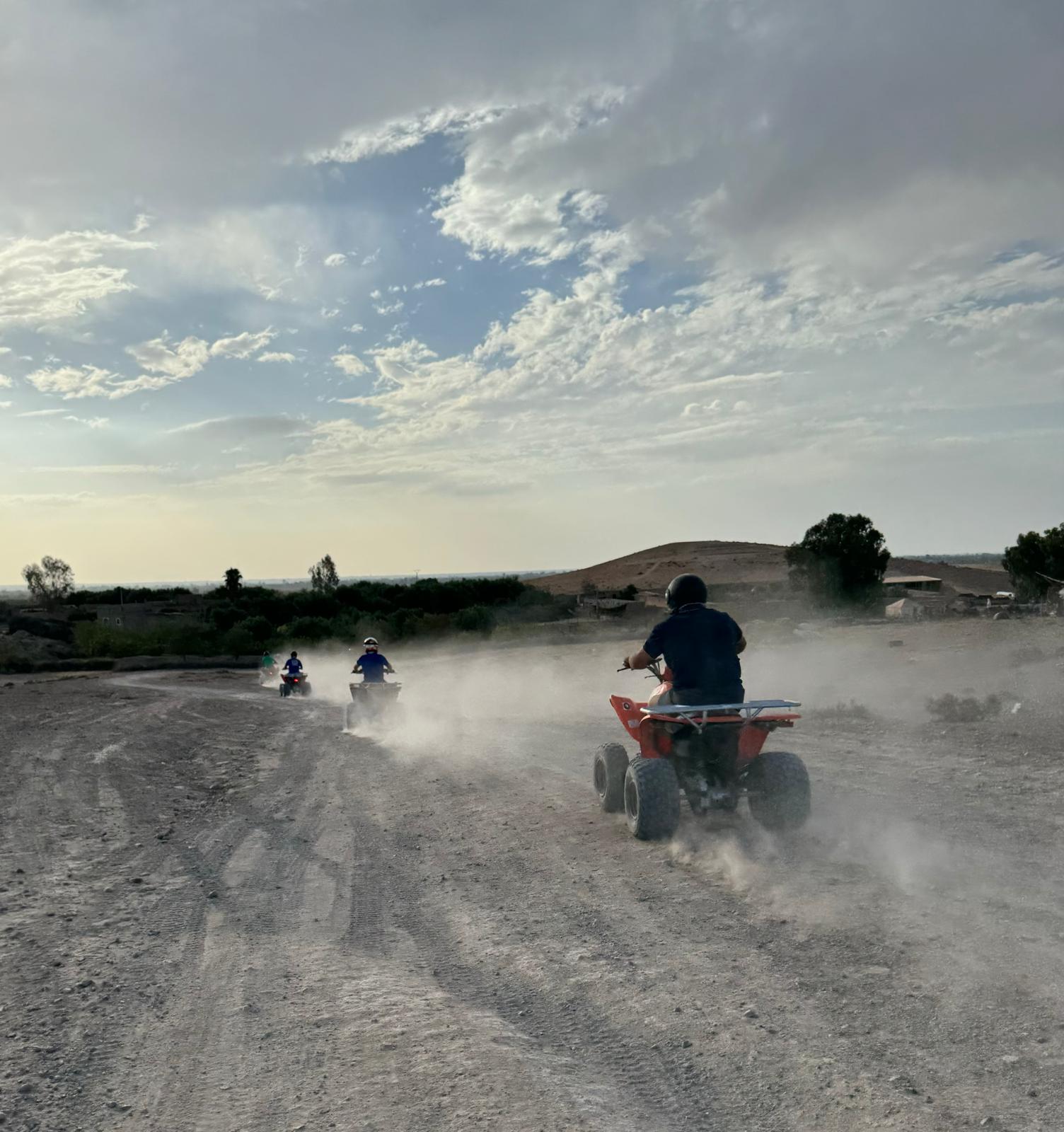Quad bikes riding through desert dust